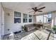 Covered patio with a comfortable wicker sectional, a ceiling fan, and views of the landscaped backyard at 3199 Great Egret Dr, Johns Island, SC 29455