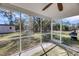 Inviting screened porch with views of the spacious backyard, a shed, and a play structure at 3199 Great Egret Dr, Johns Island, SC 29455