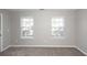 Bright bedroom with two windows and neutral gray walls and carpet at 3529 Galaxy Rd, Ladson, SC 29456