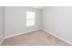 Cozy bedroom with neutral carpet, light gray walls, and a bright window at 3529 Galaxy Rd, Ladson, SC 29456
