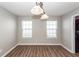 Bright dining room with hardwood floors and a modern lighting fixture at 3529 Galaxy Rd, Ladson, SC 29456