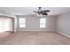 Open-concept living room with neutral walls, plush carpet, and sliding glass doors at 3529 Galaxy Rd, Ladson, SC 29456