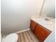 Compact powder room with a cherry vanity and wood-look vinyl flooring at 3529 Galaxy Rd, Ladson, SC 29456