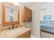 Neutral toned bathroom featuring granite countertop, wood cabinets and access to an adjacent bedroom at 3701 Docksite Rd # 108, Edisto Beach, SC 29438