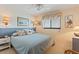 Relaxing bedroom with plush bedding, sconce lighting, and a window for natural light and views at 3701 Docksite Rd # 108, Edisto Beach, SC 29438