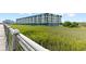 Coastal condo building with marsh views featuring balconies; a serene retreat with natural beauty and modern living at 3701 Docksite Rd # 108, Edisto Beach, SC 29438