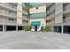 Condo exterior featuring covered parking, lush landscaping, and a welcoming entrance, combining convenience with curb appeal at 3701 Docksite Rd # 108, Edisto Beach, SC 29438