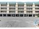 Multi-level condo featuring covered parking, balconies, and modern architectural design, offering both convenience and style at 3701 Docksite Rd # 108, Edisto Beach, SC 29438