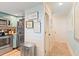 Hallway adjacent to the kitchen featuring wainscoting, storage, and access to a service entry at 3701 Docksite Rd # 108, Edisto Beach, SC 29438