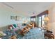 Bright living area with coastal decor, a comfortable sofa, stylish chairs, and a large window with natural light at 3701 Docksite Rd # 108, Edisto Beach, SC 29438