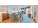Living area with coastal decor, including patterned rugs and light blue walls, and access to balcony at 3701 Docksite Rd # 108, Edisto Beach, SC 29438