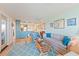 Coastal living room featuring a light blue rug, comfortable seating, and a peek into the adjacent kitchen at 3701 Docksite Rd # 108, Edisto Beach, SC 29438