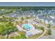 Aerial view of a community pool with umbrellas and lounge chairs, surrounded by neighborhood homes at 406 Summers Dr, Summerville, SC 29485
