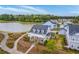 Stunning aerial view of a charming home with a welcoming front porch near a serene lake at 406 Summers Dr, Summerville, SC 29485