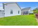 Lush backyard view showcasing well-maintained lawn, landscaping and an outdoor firepit at 406 Summers Dr, Summerville, SC 29485