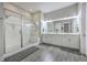 Luxurious bathroom with glass-enclosed shower and double vanity sinks and modern hardware at 406 Summers Dr, Summerville, SC 29485