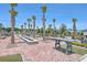 Outdoor common area with picnic tables, a water feature, palm trees, and brick pavers at 406 Summers Dr, Summerville, SC 29485