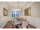Elegant dining room with large window, modern chandelier, and decorative wall art creates an inviting ambiance at 406 Summers Dr, Summerville, SC 29485