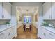 Dining room with wainscoting, tray ceiling, hardwood floors, and stylish chandelier offers an elegant dining experience at 406 Summers Dr, Summerville, SC 29485