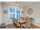 Cozy dining room with hardwood floors, large window, and decorative light fixture is perfect for Gathering gatherings at 406 Summers Dr, Summerville, SC 29485