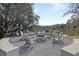 An inviting lakeside firepit with Adirondack chairs and concrete benches for relaxed outdoor enjoyment at 406 Summers Dr, Summerville, SC 29485