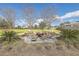 Outdoor firepit surrounded by Adirondack chairs, creating a cozy gathering space with a lush green lawn at 406 Summers Dr, Summerville, SC 29485