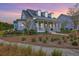 Beautiful two-story home with a covered porch, ceiling fan, lush lawn, and charming landscaping at 406 Summers Dr, Summerville, SC 29485