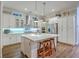 Modern kitchen with white cabinets, stainless steel appliances, a large island, and stylish pendant lighting at 406 Summers Dr, Summerville, SC 29485