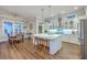 Open-concept kitchen with island seating, modern appliances, and adjacent dining area is perfect for entertaining at 406 Summers Dr, Summerville, SC 29485