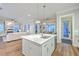 Modern kitchen island with stainless steel sink, dishwasher and breakfast bar seating flows nicely into the living area at 406 Summers Dr, Summerville, SC 29485