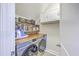 Well-organized laundry room featuring front-load washer/dryer, wooden countertop, and storage shelves and cabinets at 406 Summers Dr, Summerville, SC 29485