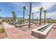 Scenic community park featuring palm trees, string lights, water features, and cozy lounge chairs at 406 Summers Dr, Summerville, SC 29485