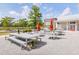Inviting outdoor patio area with picnic-style tables, umbrellas, and a building in the background at 406 Summers Dr, Summerville, SC 29485
