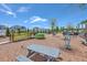Community playground with various structures and play equipment and tables, surrounded by a green space at 406 Summers Dr, Summerville, SC 29485