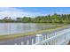 Scenic pond view with a walking path and a white picket fence, showcasing a serene outdoor space at 406 Summers Dr, Summerville, SC 29485