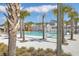 Community pool surrounded by palm trees, lounge chairs, and well-maintained landscaping at 406 Summers Dr, Summerville, SC 29485