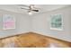 Sunlit bedroom features hardwood floors, neutral paint, and dual windows offering a serene retreat at 407 Boone Hill Rd, Summerville, SC 29483