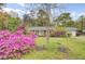 Well-maintained home with a brick facade, complemented by lush landscaping and mature trees at 407 Boone Hill Rd, Summerville, SC 29483