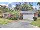 Brick house featuring a convenient attached garage and a driveway, surrounded by mature landscaping at 407 Boone Hill Rd, Summerville, SC 29483