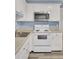 Well-lit kitchen showcasing a stainless steel microwave, electric range, and ample white cabinetry for storage at 407 Boone Hill Rd, Summerville, SC 29483