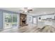 Light-filled living space boasting a brick fireplace, wood flooring, and direct access to the backyard at 407 Boone Hill Rd, Summerville, SC 29483
