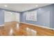 Spacious living room with blue walls, hardwood floors, and natural light at 407 Boone Hill Rd, Summerville, SC 29483