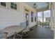 Inviting back porch with outdoor furniture and a view of the surrounding neighborhood at 4303 Misty Hollow Ln, Ravenel, SC 29470