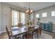 Well-lit dining room with wood table and stylish light fixture at 4303 Misty Hollow Ln, Ravenel, SC 29470
