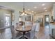 Charming dining area with wood table and stylish light fixture at 4303 Misty Hollow Ln, Ravenel, SC 29470