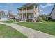 Charming two-story home with a double porch, manicured lawn, and inviting curb appeal at 4303 Misty Hollow Ln, Ravenel, SC 29470