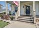 Inviting front porch with rocking chairs, a decorative door wreath, and charming details at 4303 Misty Hollow Ln, Ravenel, SC 29470