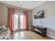 A modern living room with hardwood floors, French doors, and a mounted television at 4303 Misty Hollow Ln, Ravenel, SC 29470