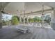 Charming outdoor seating area under a covered pavilion, ideal for relaxing and enjoying the serene natural surroundings at 4303 Misty Hollow Ln, Ravenel, SC 29470
