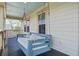 Relaxing porch swing adorned with pillows, offering a cozy spot to unwind with a view of the neighborhood at 4303 Misty Hollow Ln, Ravenel, SC 29470